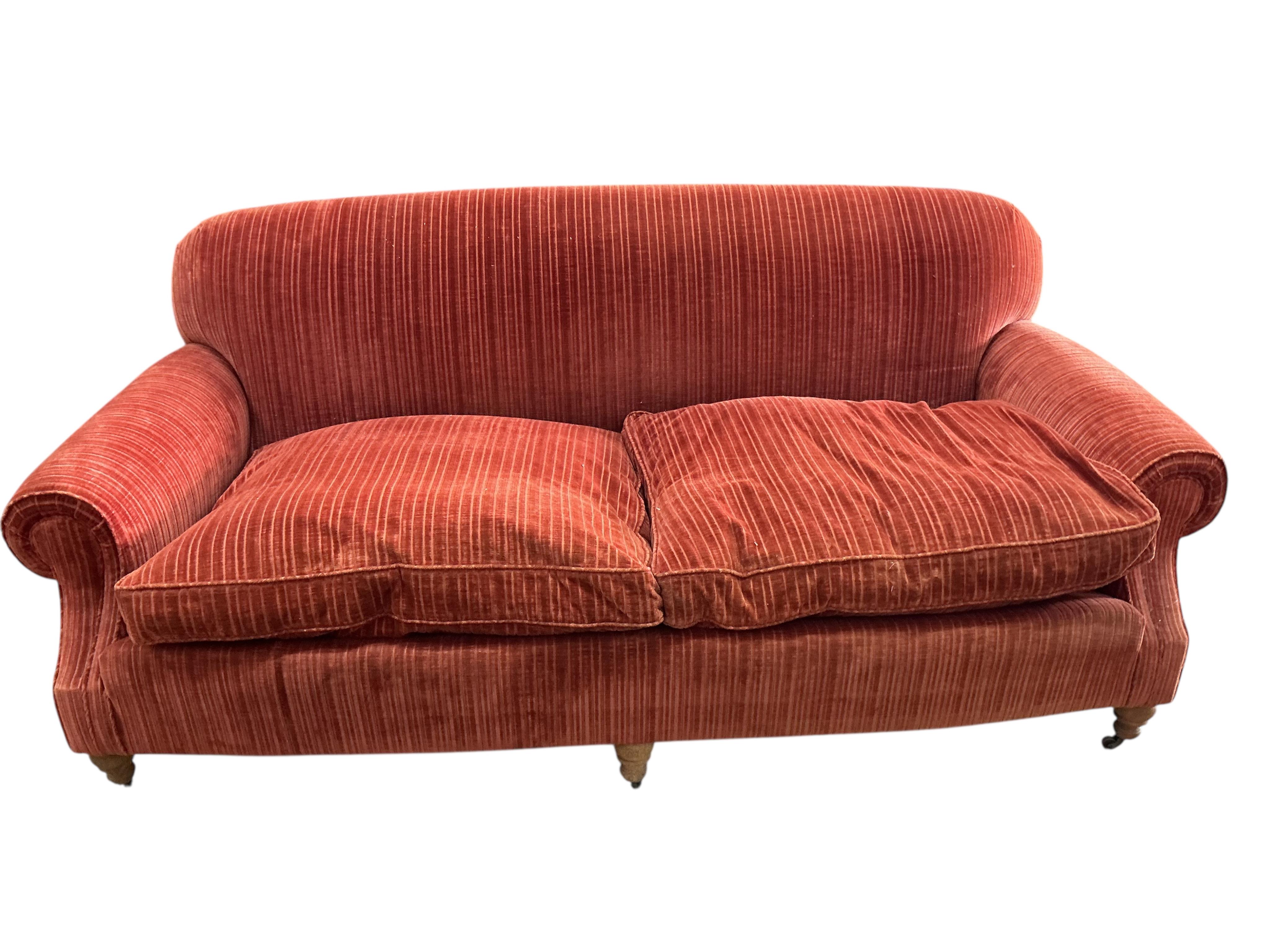 A modern Howard style upholstered two seater settee, width 206cm, depth 92cm, height 84cm, Provenance: The late Kenneth Turner (1936-2025), celebrity florist, designer and perfume retailer, he received the Royal Warrant